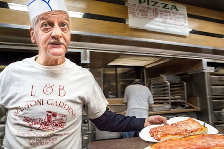 If there is anyone you don’t want to be on bad terms with in Bensonhurst, it’s the man who slices the trays at L&B’s. A summer in Brooklyn is incomplete without devouring at least a dozen Sicilian squares and twice as many spumoni ices.  