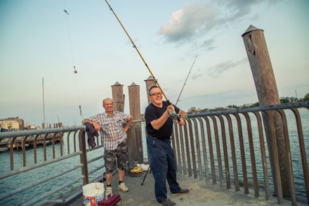 Tahir and his friend, both local Turks, fish off the pier for Lafayettes, while larger fishing boats head out to catch Blues and Bass. It has been a slow year, but they keep faith that as the tide comes in so will the fish.