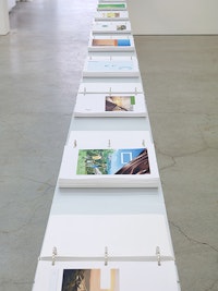 Marc Handelman, The Triple Bottom Line, 2011 – 2015. 2700 Archival Inkjet prints, 18 aluminum binders, steel table. 462 2/5 x 32 1/2 x 11 3/4 inches. Courtesy the Artist and Sikkema Jenkins & Co., New York.