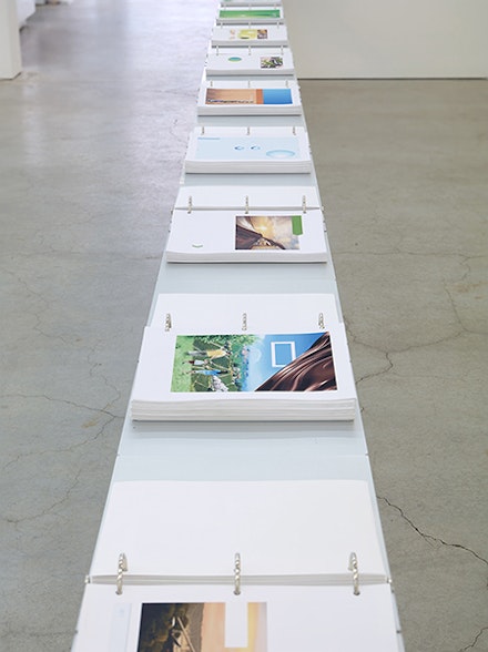 Marc Handelman, The Triple Bottom Line, 2011 – 2015. 2700 Archival Inkjet prints, 18 aluminum binders, steel table. 462 2/5 x 32 1/2 x 11 3/4 inches. Courtesy the Artist and Sikkema Jenkins & Co., New York.
