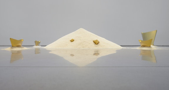 Wolfgang Laib, <em>Passageway</em>, 2013. 7 brass ships, rice, 18 x 128 x 102 inches. Courtesy the Artist and Sperone Westwater, New York