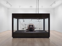 Kevin Beasley, <i>A view of a landscape: A cotton gin motor</i>, 2012-18. Installation view, Whitney Museum of American Art, New York, 2018-2019. GE induction motor, custom soundproof glass chamber, anechoic foam, steel wire, monofilament, cardioid condenser microphones, contact microphones, microphone stands, microphone cables, and AD/DA interface. Courtesy Casey Kaplan, New York. Photo: Ron Amstutz.