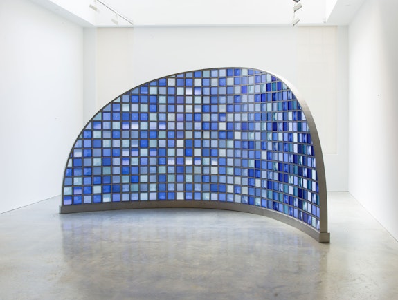 Josiah McElheny, <em>Moon Mirror</em>, 2019. Pressed colored prismatic glass, stainless steel, hardware, 103 x 191 1/2 x 71 inches. © Josiah McElheny 2019. Courtesy the artist and James Cohan, New York.  