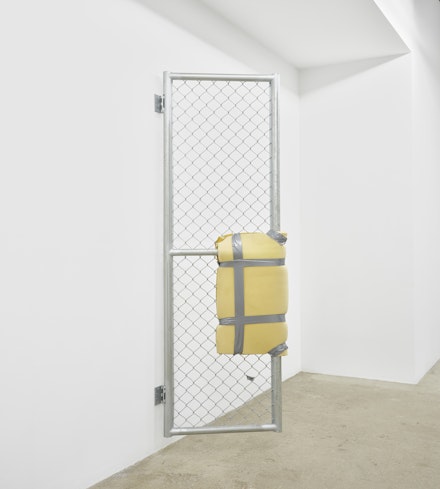 Bat-Ami Rivlin, <em>Untitled (metal gate, yellow foam, duct tape)</em>, 2019. Chain link fencing, metal frame, hinges, polyisocyanurate foam, duct tape, hardware, 84 1/2 x 5 x 24 inches. Courtesy M 2 3, New York.