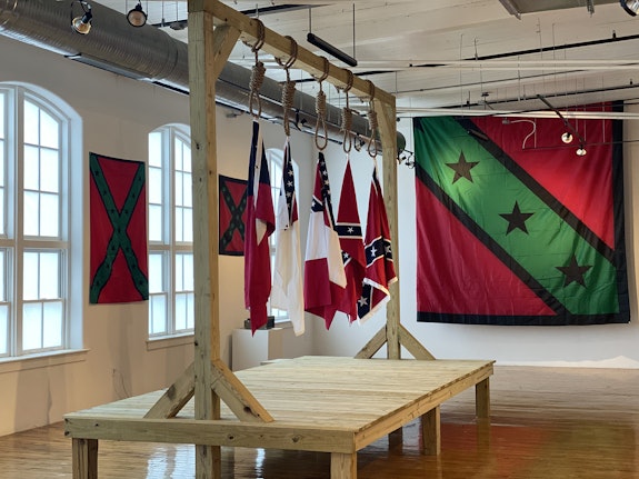 Installation shot of <em>AfroDixia: A Righteous Confiscation</em>, 2021. Featured work: John Sims, <em>The Proper Way to Hang Five Major Confederate Flags</em> 2021, at the 701 Center for Contemporary Art, Columbia, SC. Courtesy the artist.