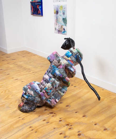 Louis Osmosis, <em>Various Masses</em>, 2022. Reinforced paper-mache, inkjet prints, polystyrene, concrete, plaster, enamel paint, polyurethane, branch, grocery bag, stuffing, 63 x 62 x 38 inches. Courtesy of the artists and Kapp Kapp. Image credit © Jason Mandella.