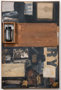 Robert Rauschenberg, <em>Talisman</em>, 1958. Combine: oil, paper, printed paper, printed reproductions, wood, glass jar on metal chain and fabric on canvas, 42 1/8 x 28 x 4 1/2 inches. Des Moines Art Center, Iowa. Purchased with funds from the Coffin Fine Arts Trust; Nathan Emory Coffin Collection of the Des Moines Art Center, 1969. © 2022 Robert Rauschenberg Foundation / Licensed by VAGA at Artists Rights Society (ARS), NY.