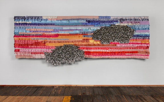 Marie Watt, <em>Companion Species (First and Last)</em>, 2023. Reclaimed satin bindings, industrial felt, tin jingles, cotton twill tape, and thread, 50.5 x 169.5 in. Courtesy of the Artist and MARC STRAUS. Photography by Kevin McConnell.