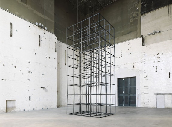 Installation view: <em>Mona Hatoum: all of a quiver</em>, KINDL Centre for Contemporary Art, Kesselhaus, Berlin, 2022. Aluminium square tubes, steel hinges, electric motor and cable, 339 x 151 1/2 x 114 inches. Courtesy KINDL Centre for Contemporary Art, Kesselhaus. Photo: Jens Ziehe.