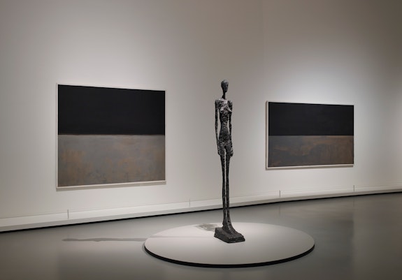Installation view: <em>Mark Rothko</em>, Gallery 10, Floor 2, Fondation Louis Vuitton, Paris, 2023–24. Left to right: Mark Rothko, Untitled, 1969; Untitled, 1969. Sculpture: Alberto Giacometti, <em>Grande Femme III</em>, 1960. © 1998 Kate Rothko Prizel & Christopher Rothko - Adagp, Paris, 2023.