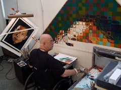 The painter in his studio (in the process of making a portrait of Zhang Huan). Courtesy of Chuck Close studio.  
