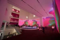 Installation view of Pipilotti Rist's Pour Your Body Out (7354 Cubic Meters) at The Museum of Modern Art, 2008. Multichannel video projection (color, sound), projector enclosures, circular seating element, carpet. Courtesy the artist, Luhring Augustine, New York, and Hauser and Wirth Z üich London. © 2008 Pipilotti Rist. Photo: © Frederick Charles, fcharles.com.