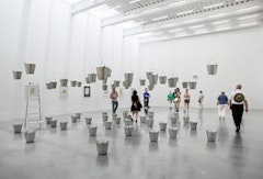 Rivane Neuenschwander, “Chove Chuva/Rain Rains” (2002). Aluminum buckets, water, steel cable, ladder, dimensions variable. Installation View, The New Museum. Photos by Benoit Pailley.