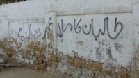 In Urdu, the wall says “Mulla Omar of the Taliban is the devil incarnate.” Photos by Rehan Ansari.